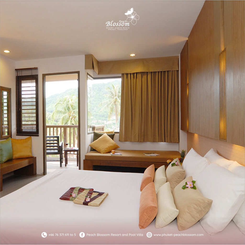 Cosy mountain-view resort room with seating area at Peach Blossom Phuket